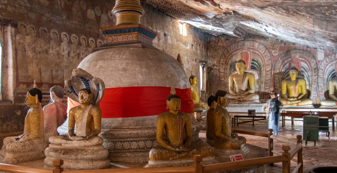 Dagoba surrounded by eleven seated Buddhas inside the largest cave at Dambulla Cave Temple in Sri Lanka