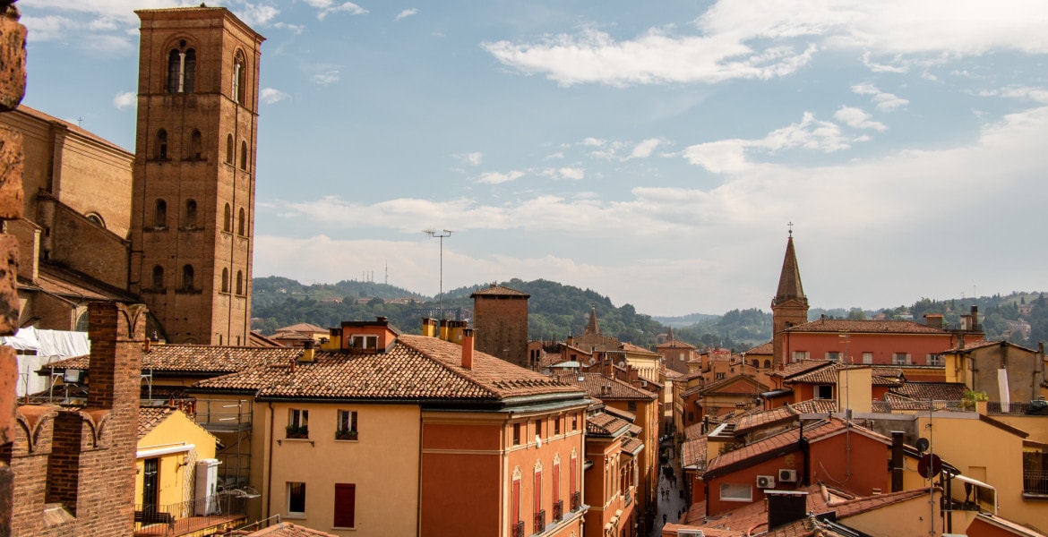View over the old town of Bologna with its terracotta colored houses from the tower of Torre Dell’ Orologio located on the Piazza Maggiore.
