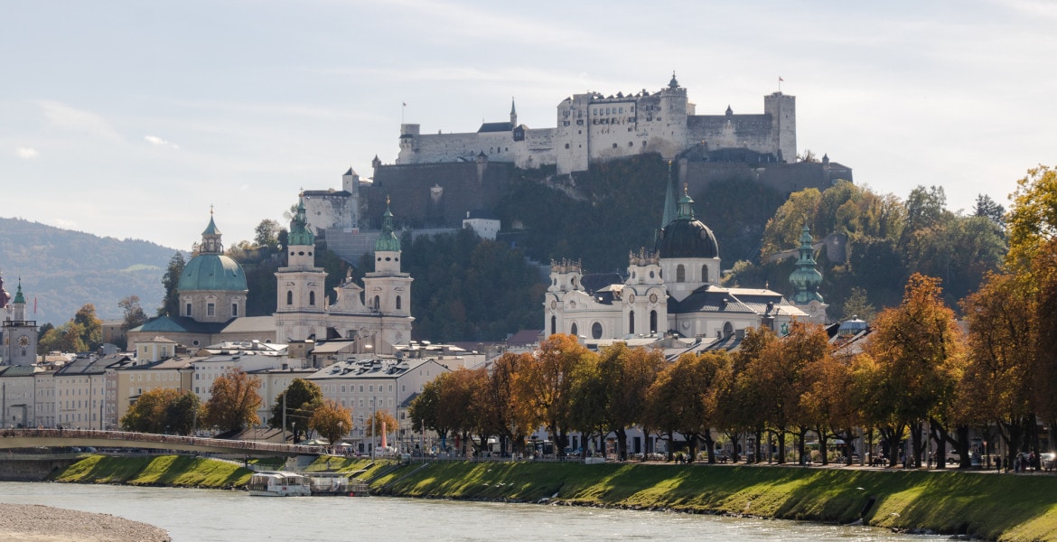 View of Hohensalzburg Fortress in Salzburg Austria on the hill with the old town and the river in the front