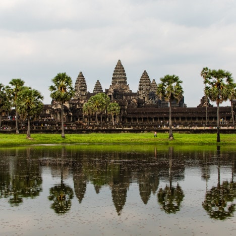 View over the famous Angkor Wat, a Hindu-Buddhist temple in Cambodia, from across a waterpond.