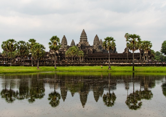 View over the famous Angkor Wat, a Hindu-Buddhist temple in Cambodia, from across a waterpond.