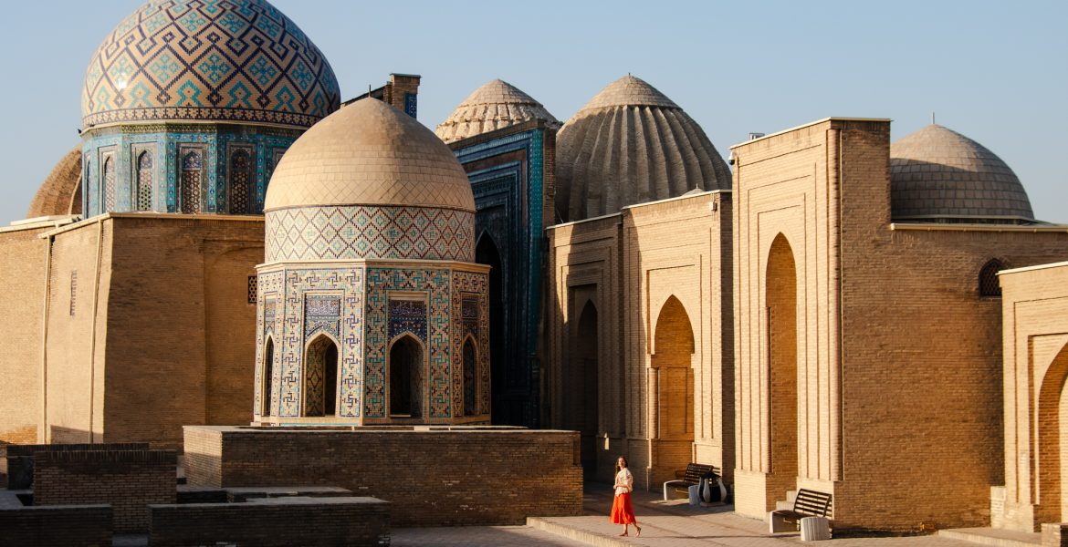 Sunrise over the sandstone colored tombs and mausoleums of Shah-I-Zinda, a necropolis known for its islamic architecture with domes covered in turquoise mosaics and beautiful tilework in Samarkand, Uzbekistan