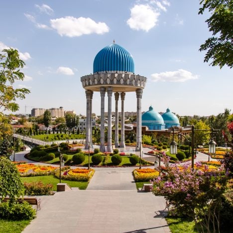 Flower beds and gazebo-shaped structure with a blue turquoise dome of the Memorial to the Victims of Repression in Tashkent Uzbekistan