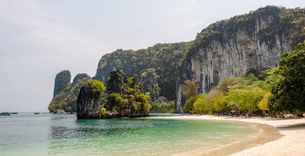 The white sandy beach and turquoise blue clear water of Hong Island with limestone formations around in Krabi Thailand