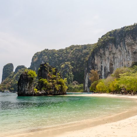 The white sandy beach and turquoise blue clear water of Hong Island with limestone formations around in Krabi Thailand