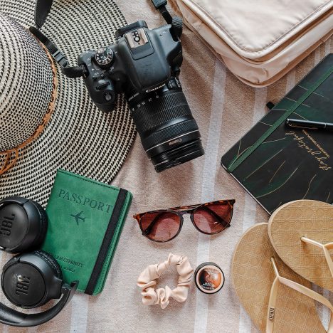 Flat Lay of essential travel gear and camera equipment for a trip to Thailand