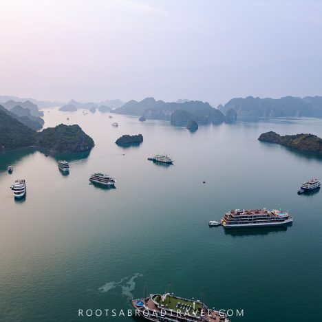 Drone shot view of Halong bay with its cruise boats in between the limestone formations in the water