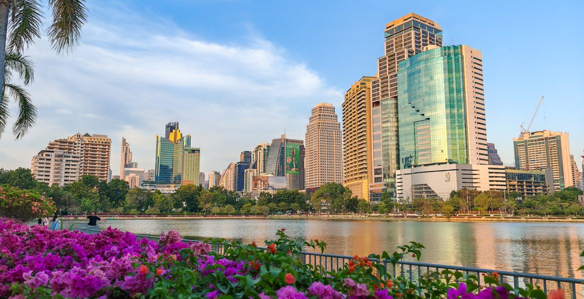 Lake at Benchakitti Park in Bangkok with towering buildings in the back