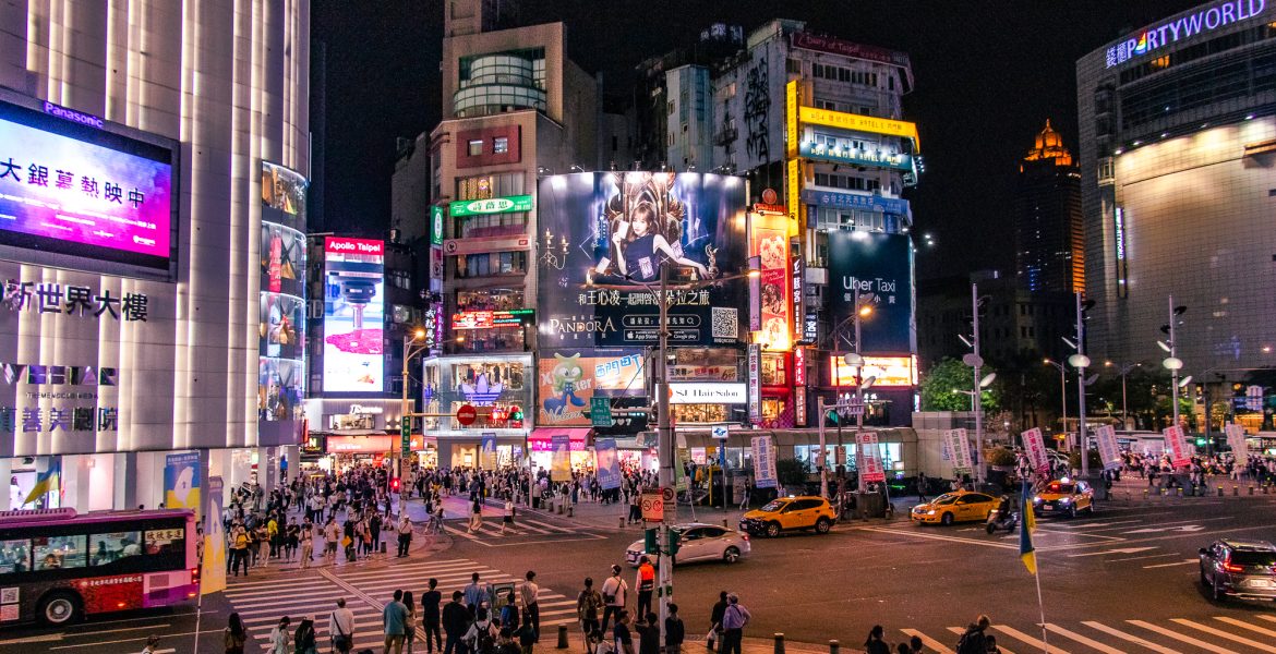 The bustling square at Ximending with neon lights, colorful billboards and high buildings