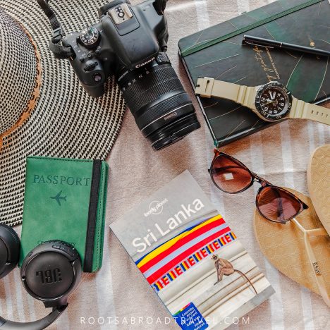 Flat lay of must take items for a trip to Sri Lanka such as passport and camera