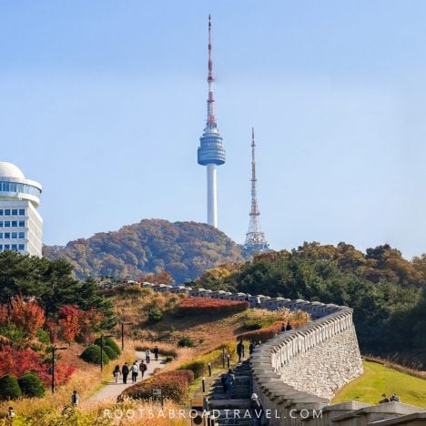 View of the N Seoul Tower from Namsan Baekbeom Square with the old city wall in Seoul South Korea