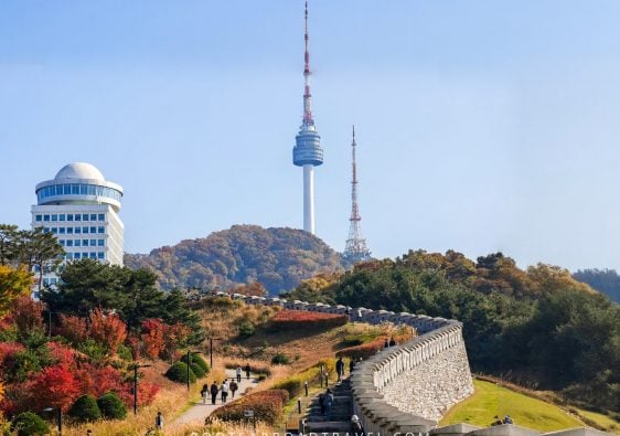 View of the N Seoul Tower from Namsan Baekbeom Square with the old city wall in Seoul South Korea