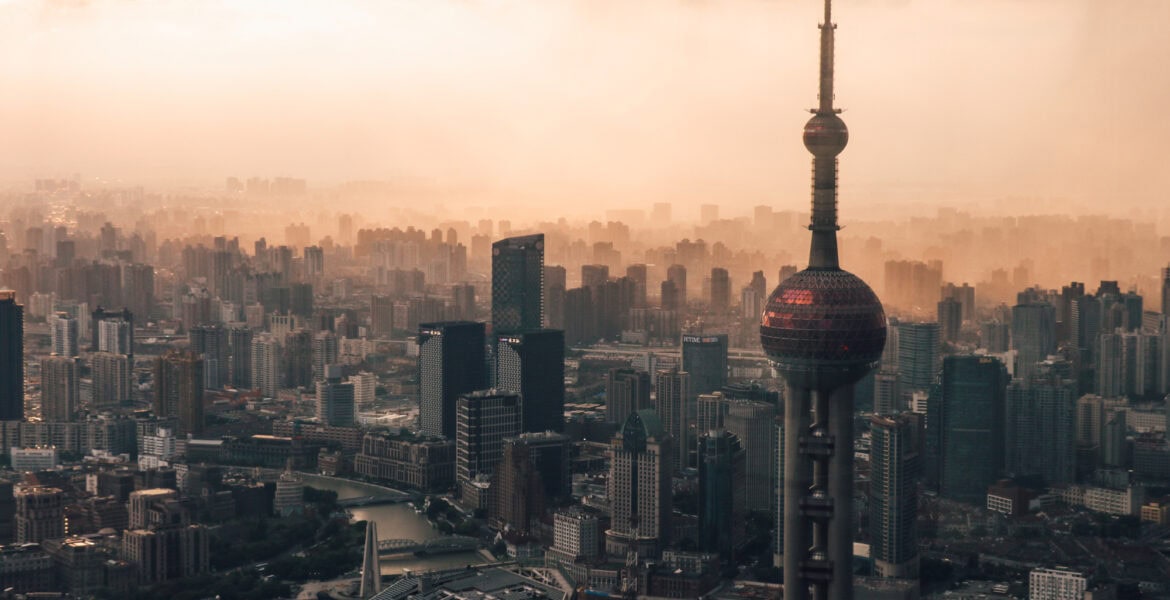 City skyline view with the Oriental Pearl tower in the foreground during sunset from Shanghai tower